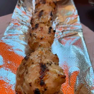 a chicken skewer on a stick