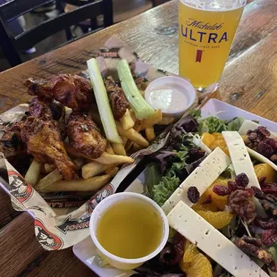 Chicken wings, salad, and beer.