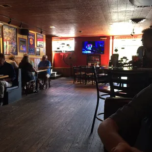 people sitting at tables and watching tv
