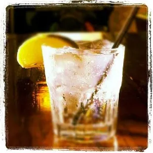 a glass of ice and a lemon slice