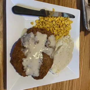 Chicken fried steak, mashed potatoes and corn