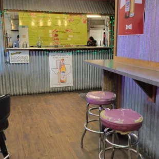 Inside has a few seats. Opposite direction is the gas station area.