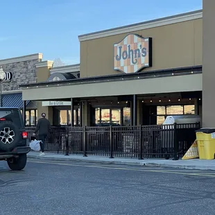 a truck parked in front of a restaurant