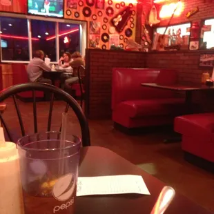 ows a glass of iced tea and a fork on a table