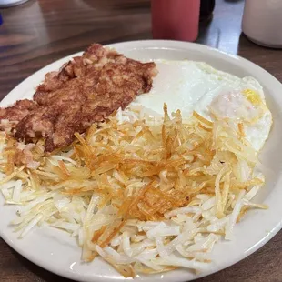 Corn Beef Hash with 3 Eggs Any Style , and  hash browns.