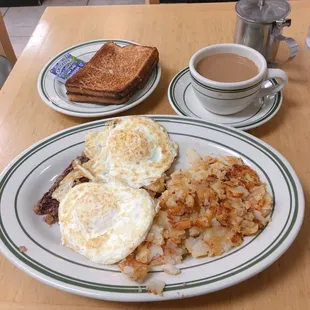 a breakfast of eggs, hash browns and toast