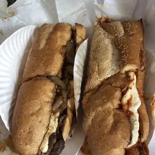 two sandwiches on a paper plate