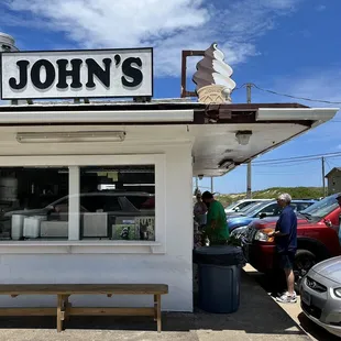people standing outside of a restaurant