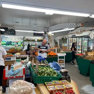 a man and woman shopping for produce