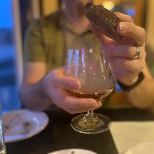 a glass of wine and a chocolate biscuit