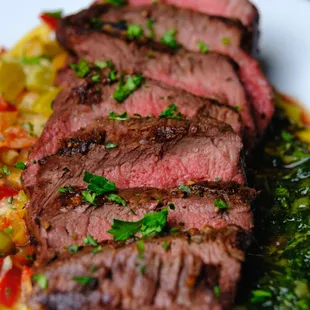 Flank steak appetizer with mint chimichurri and pepper relish