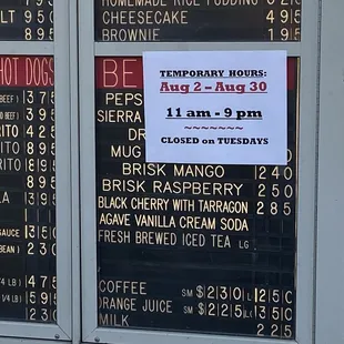 Temporarily closed on TUESDAY's sign at John's on Spring Street in Long Beach, CA. Sign on drive through order's Menu board