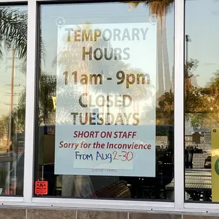 Temporarily closed on TUESDAY's sign at John's on Spring Street in Long Beach, CA window sign for Tue 8/2-30/2021