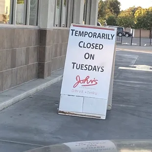Temporarily closed on TUESDAY's sign at John's on Spring Street in Long Beach, CA . Close Up