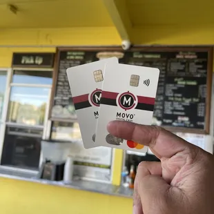 a hand holding two cards