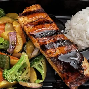 a meal of salmon, vegetables and rice