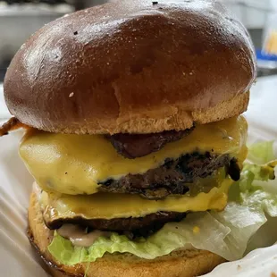 a cheeseburger in a styrofoam container