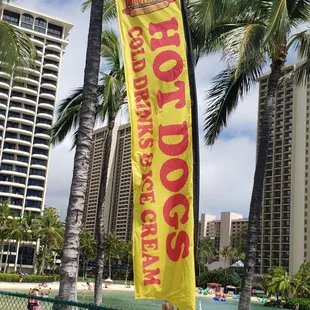 a yellow banner with the words hot dogs on it