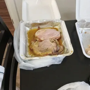 a chicken in a foil container