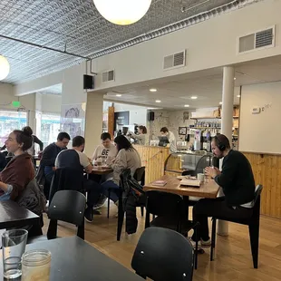 people sitting at tables in a restaurant