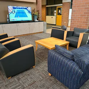 Inside lobby of Johnson Ranch Sports Club South - Large Screen TV set to US Open