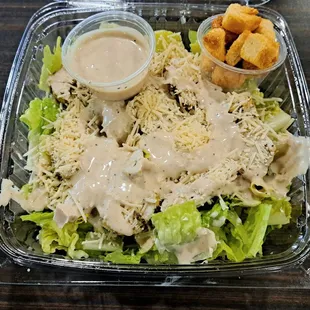 Chicken Caesar Salad. I requested more dressing to be poured on top. Dressing on the side by default.