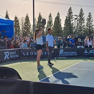 Jorja Johnson sings "Sweet Caroline" next to her doubles partner, brother JW Johnson.