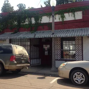 Grass growing all over the front entrance of business