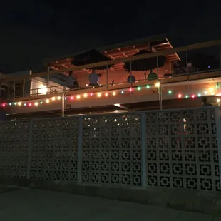 Privacy wall, cute lights, slide poking out on the left, facing the street in downtown Raleigh (on Johnson Street)