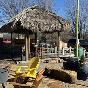  yellow chairs and a thatched umbrella