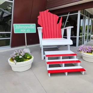 a red adiron and a white chair