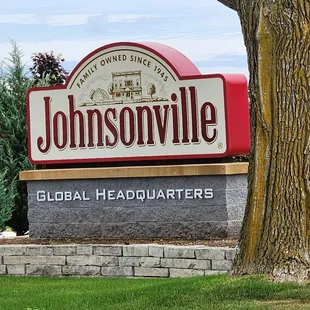 a sign in front of a tree