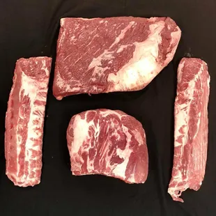three pieces of meat on a black surface