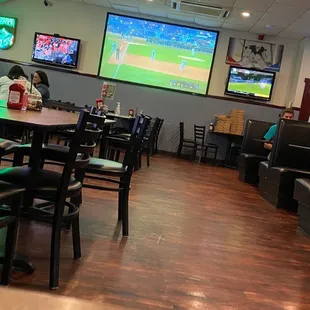 a man sitting at a table in a sports restaurant