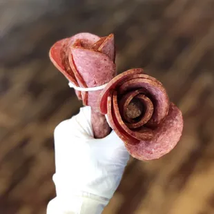 a hand holding a piece of meat