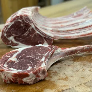 two pieces of raw meat on a cutting board