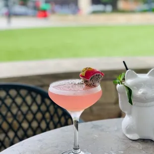 a pink cocktail with a strawberry garnish garnish garnish garnish garnish garnish