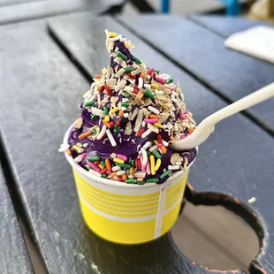 Ube soft serve with coconut flakes and sprinkles