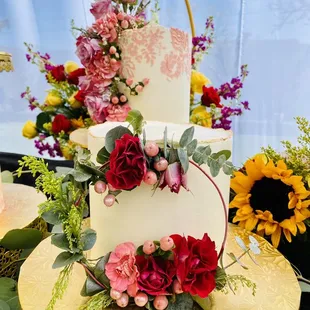 a three tiered cake decorated with flowers