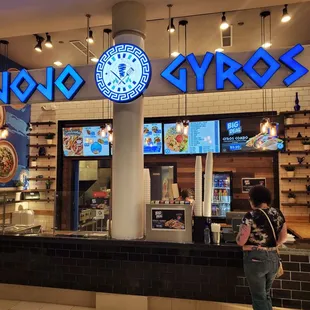 a woman standing in front of a restaurant