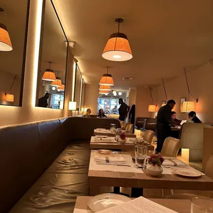 the interior of a restaurant with tables and chairs