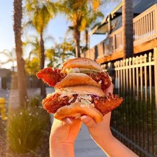 a hand holding a sandwich