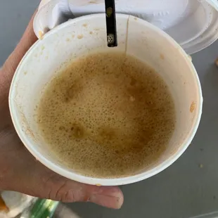 a person holding a cup of coffee