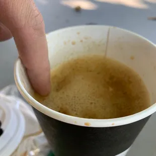 a hand holding a cup of coffee