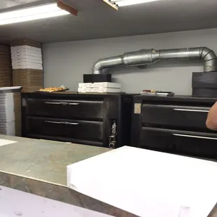 a man taking a picture of a woman in a kitchen