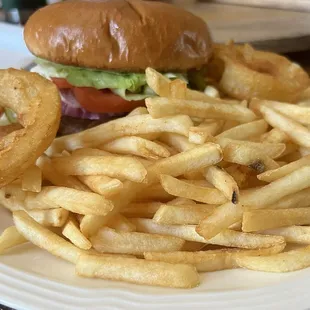 Hamburger with fries and some onion rings.