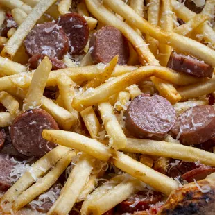 a pizza with french fries and sausage