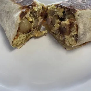 Country burrito was so good. home fries, scrambled eggs, sausage, ham, gravy I think cheese with sour cream and super yummy salsa.