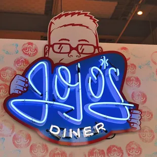 a neon sign for jojo&apos;s diner