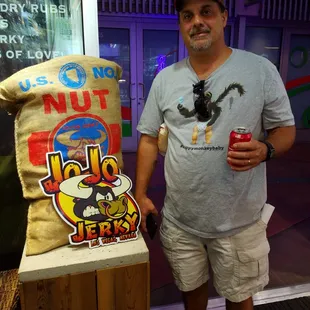 a man standing next to a bag of food